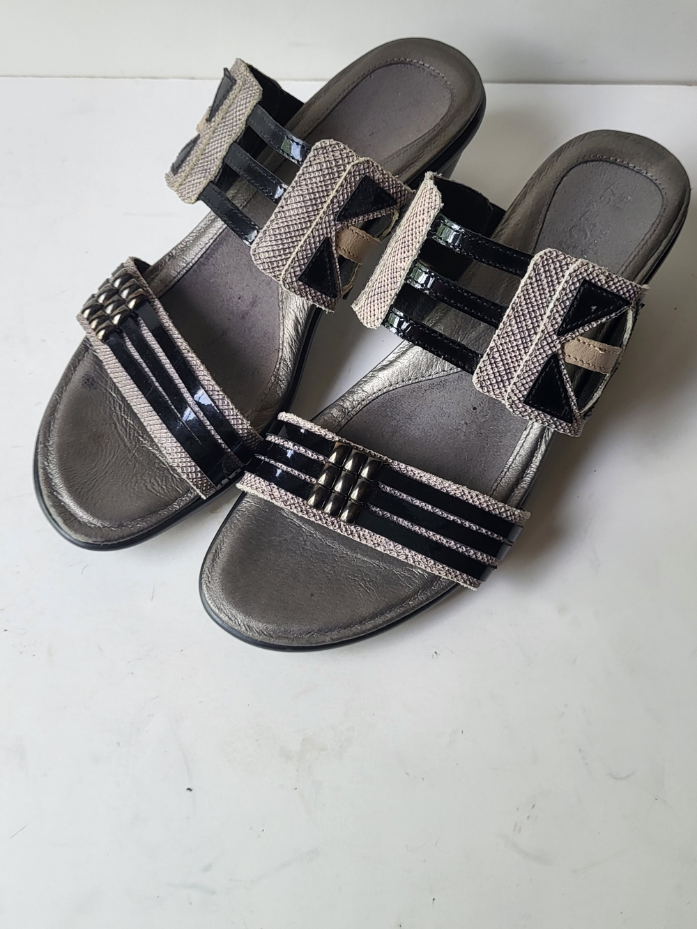 Naot Black and Taupe Slip-On Sandals with Buckle Detail